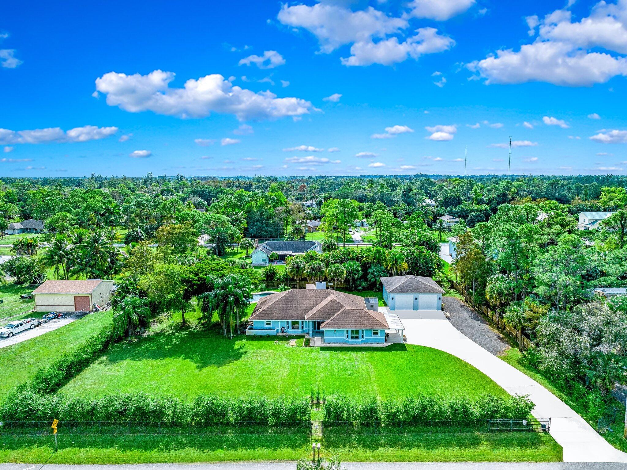 9268 Rodeo Drive Lake Worth, FL 33467 - Photo 2 of 66 a view of an outdoor space and a yard