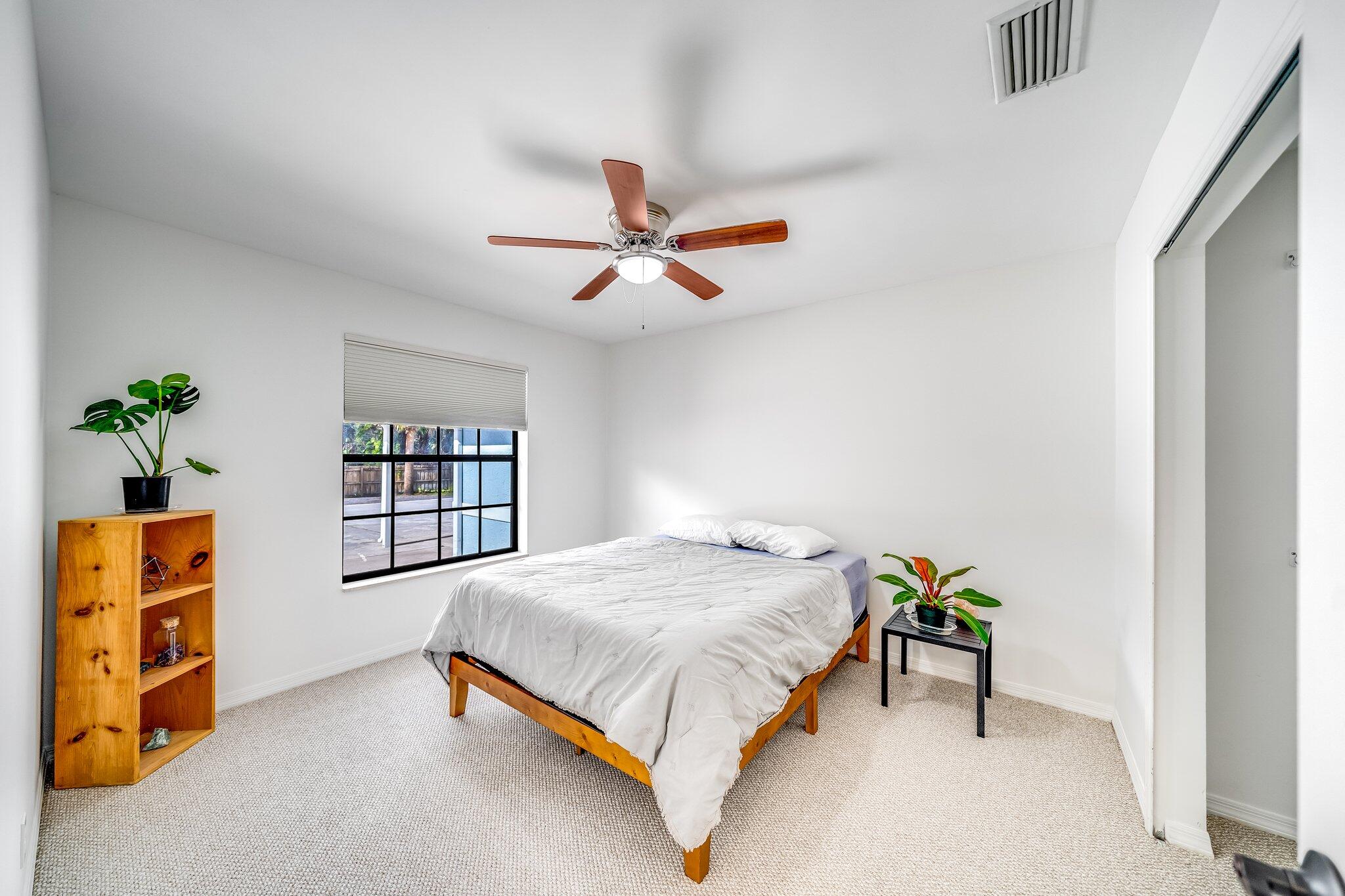 9268 Rodeo Drive Lake Worth, FL 33467 - Photo 23 of 66 a bedroom with a bed closet and a window