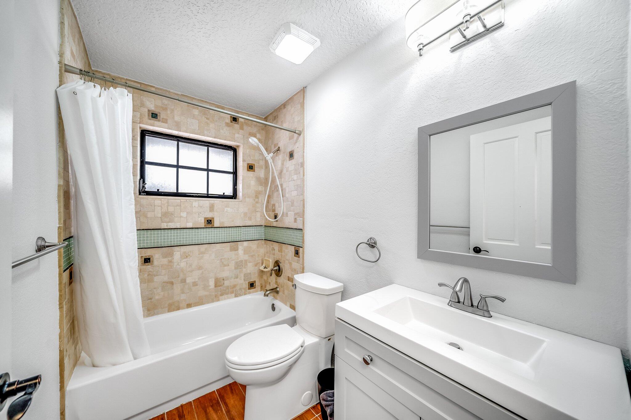 9268 Rodeo Drive Lake Worth, FL 33467 - Photo 24 of 66 a bathroom with a sink toilet and shower