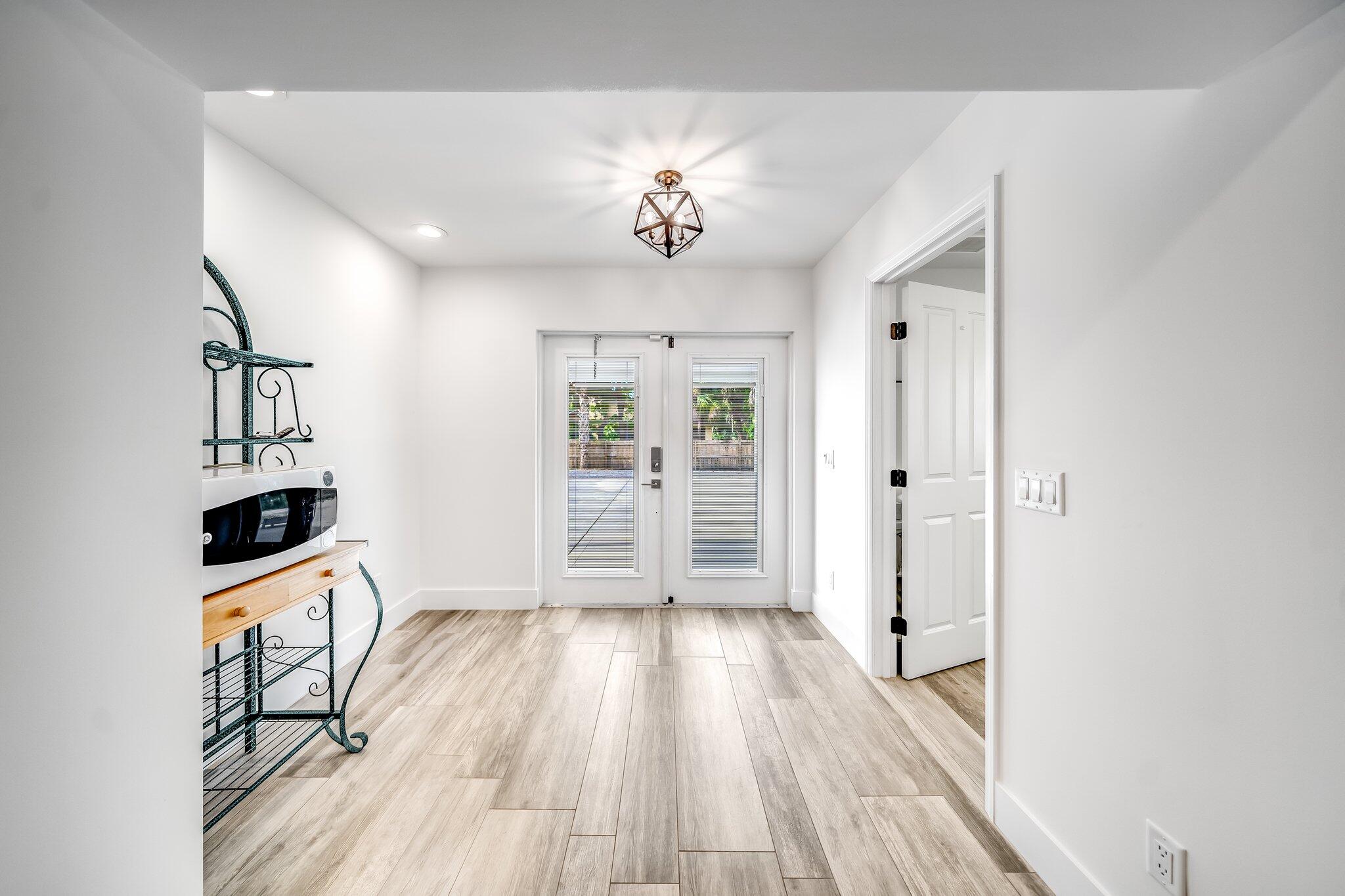 9268 Rodeo Drive Lake Worth, FL 33467 - Photo 27 of 66 wooden floor in an empty room with a window