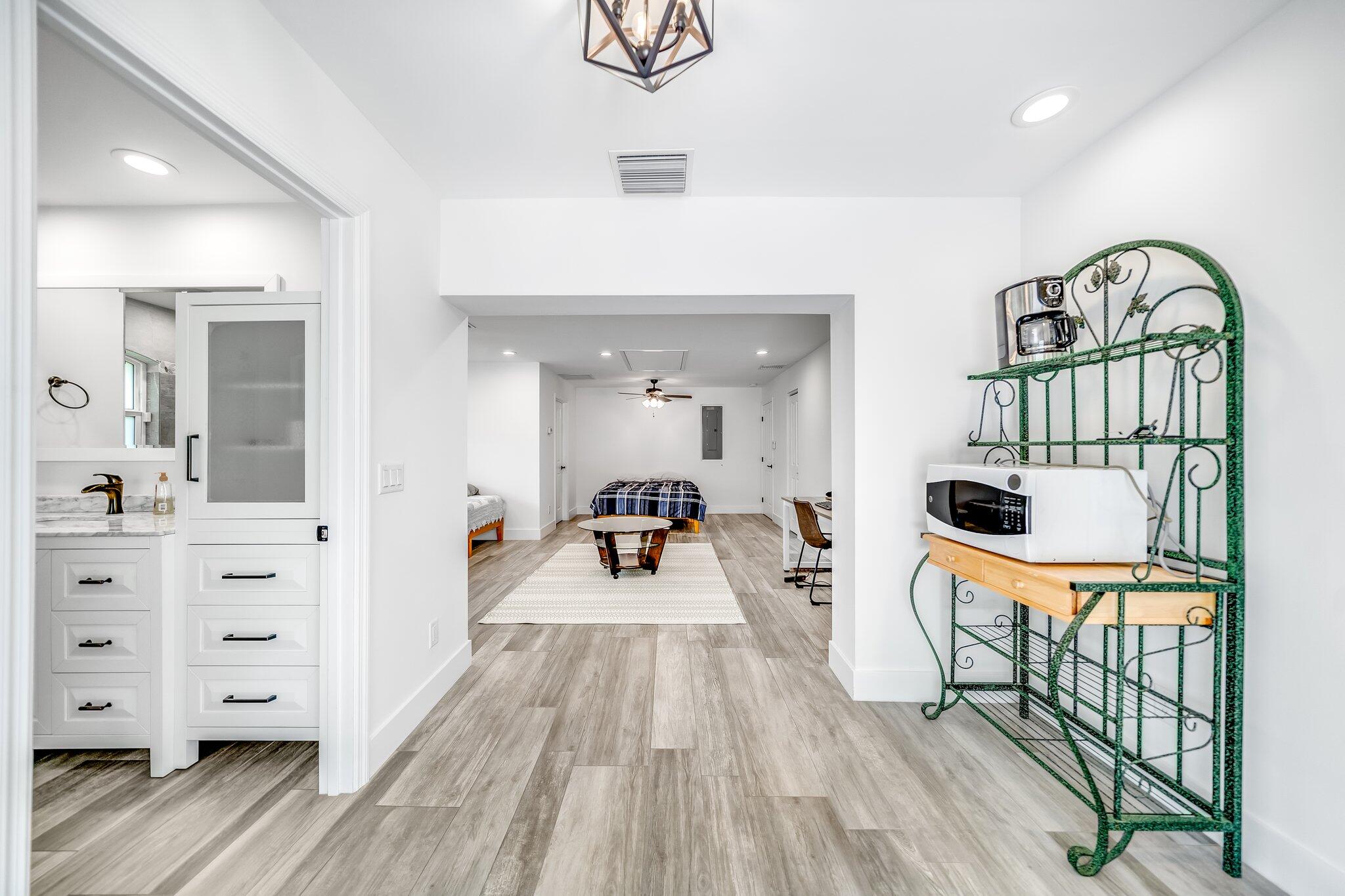 9268 Rodeo Drive Lake Worth, FL 33467 - Photo 28 of 66 a living room with furniture a flat screen tv and a large window
