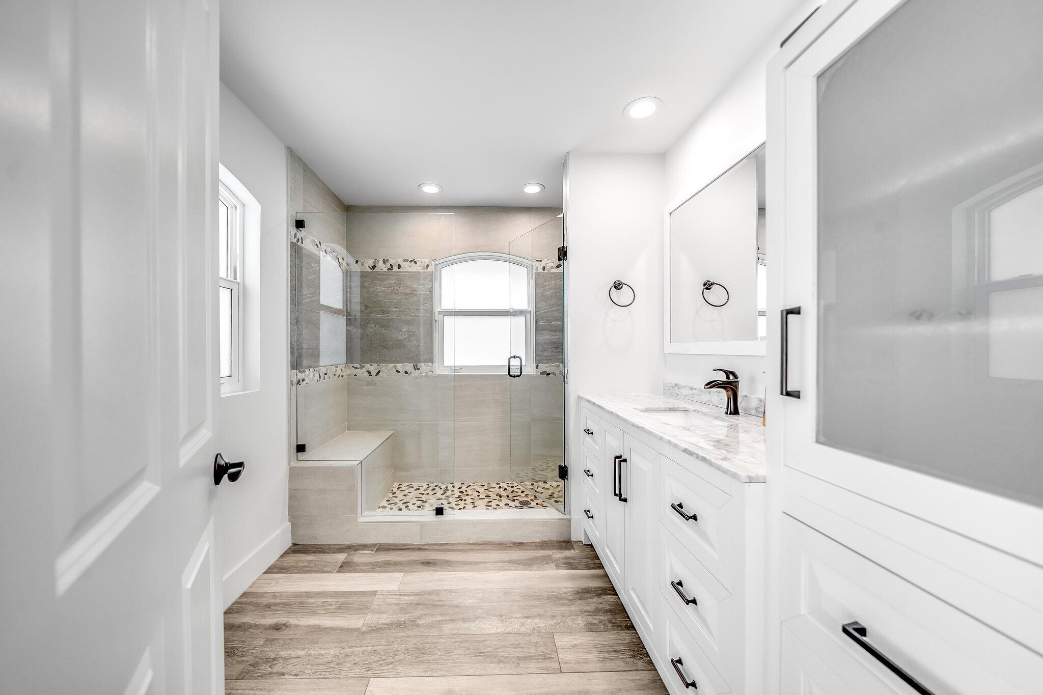 9268 Rodeo Drive Lake Worth, FL 33467 - Photo 29 of 66 a spacious bathroom with double vanity and mirrors