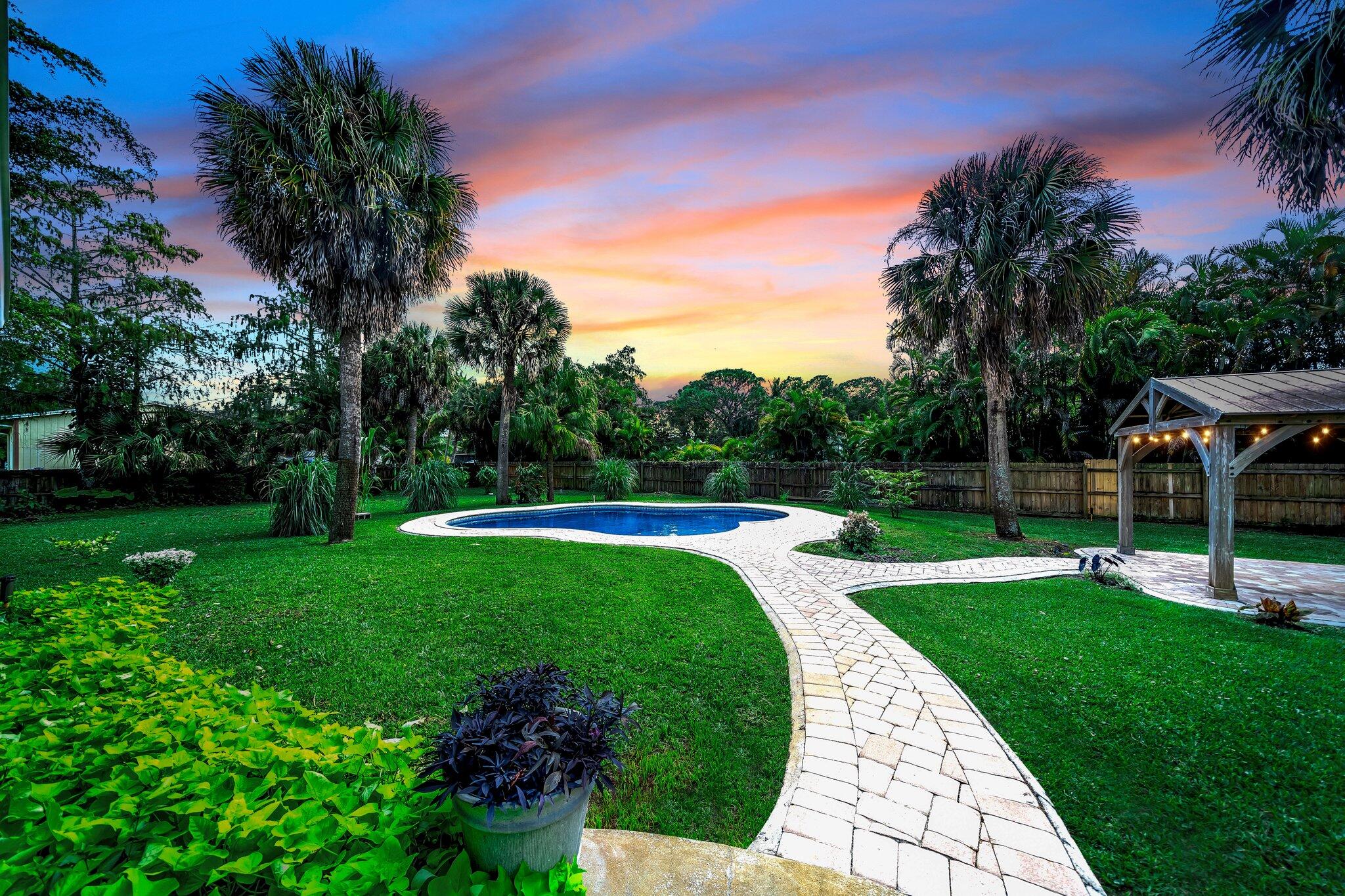 9268 Rodeo Drive Lake Worth, FL 33467 - Photo 40 of 66 a view of a garden with a slide