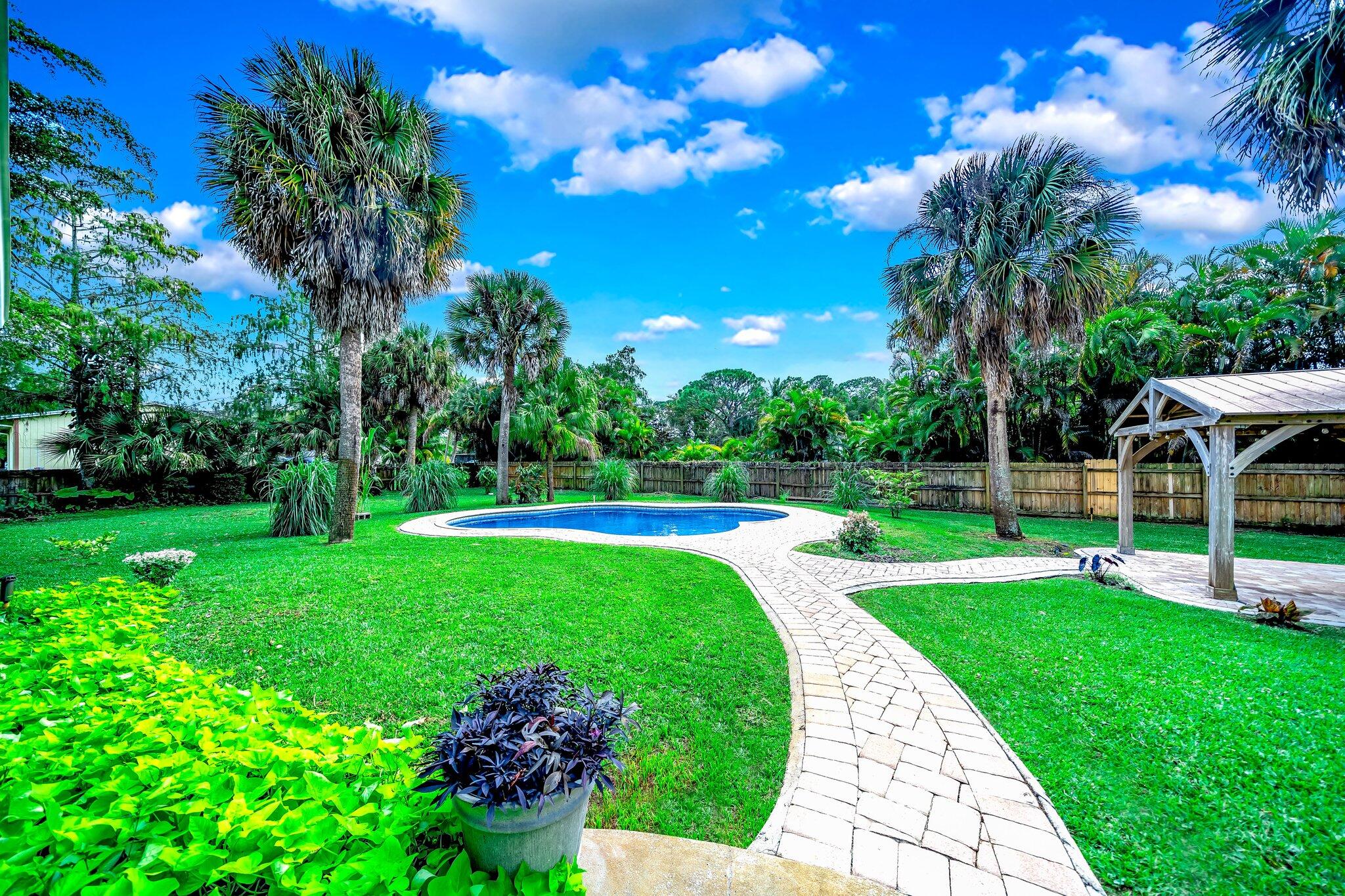 9268 Rodeo Drive Lake Worth, FL 33467 - Photo 43 of 66 a view of a house with a backyard porch and sitting area