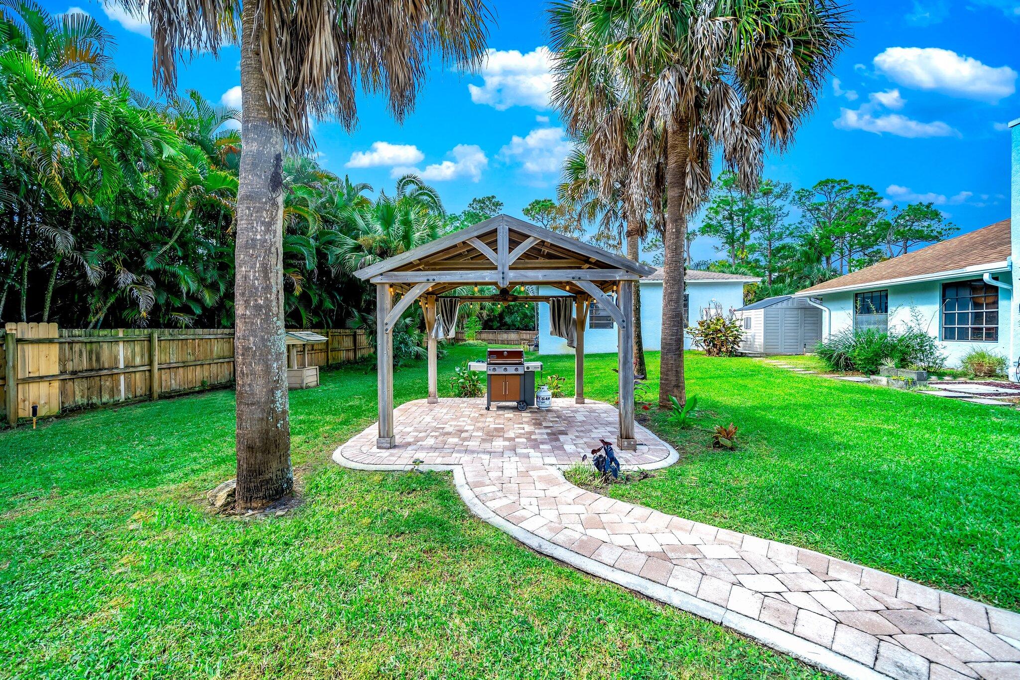 9268 Rodeo Drive Lake Worth, FL 33467 - Photo 46 of 66 a front view of a house with a yard