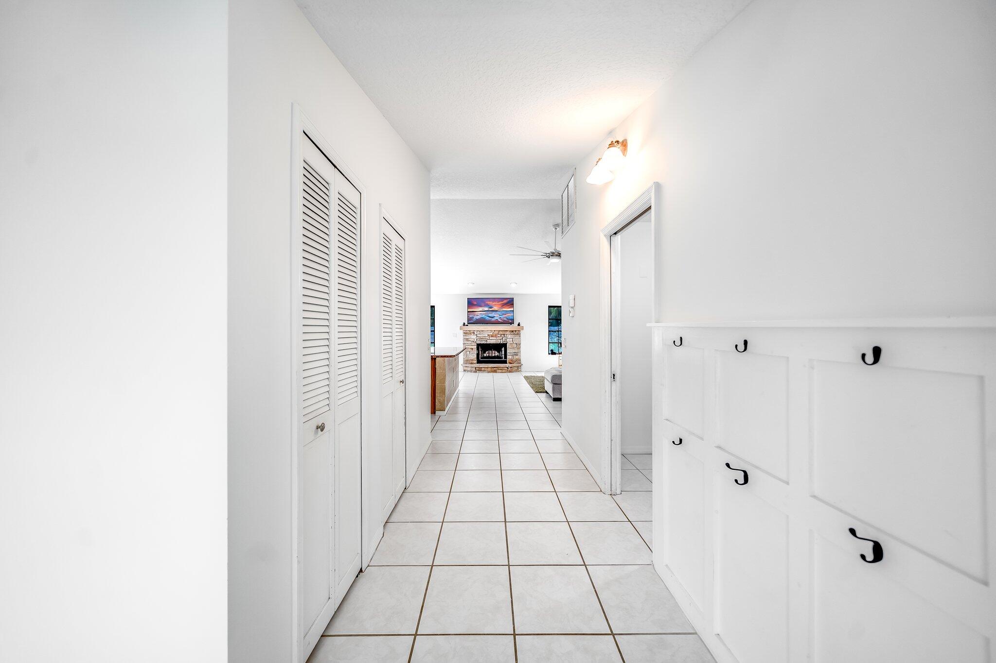 9268 Rodeo Drive Lake Worth, FL 33467 - Photo 5 of 66 a view of a hallway view with wooden floor and staircase