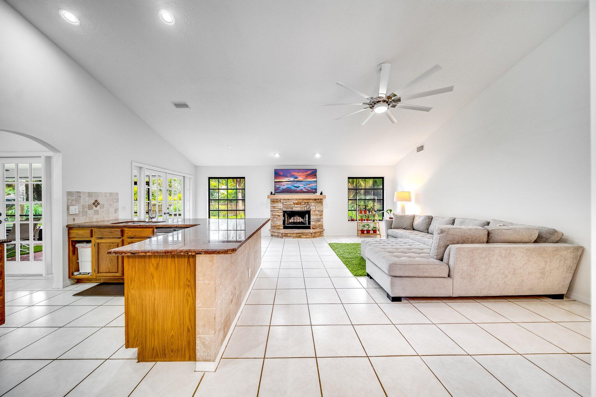9268 Rodeo Drive Lake Worth, FL 33467 - Photo 6 of 66 a living room with furniture and a fireplace