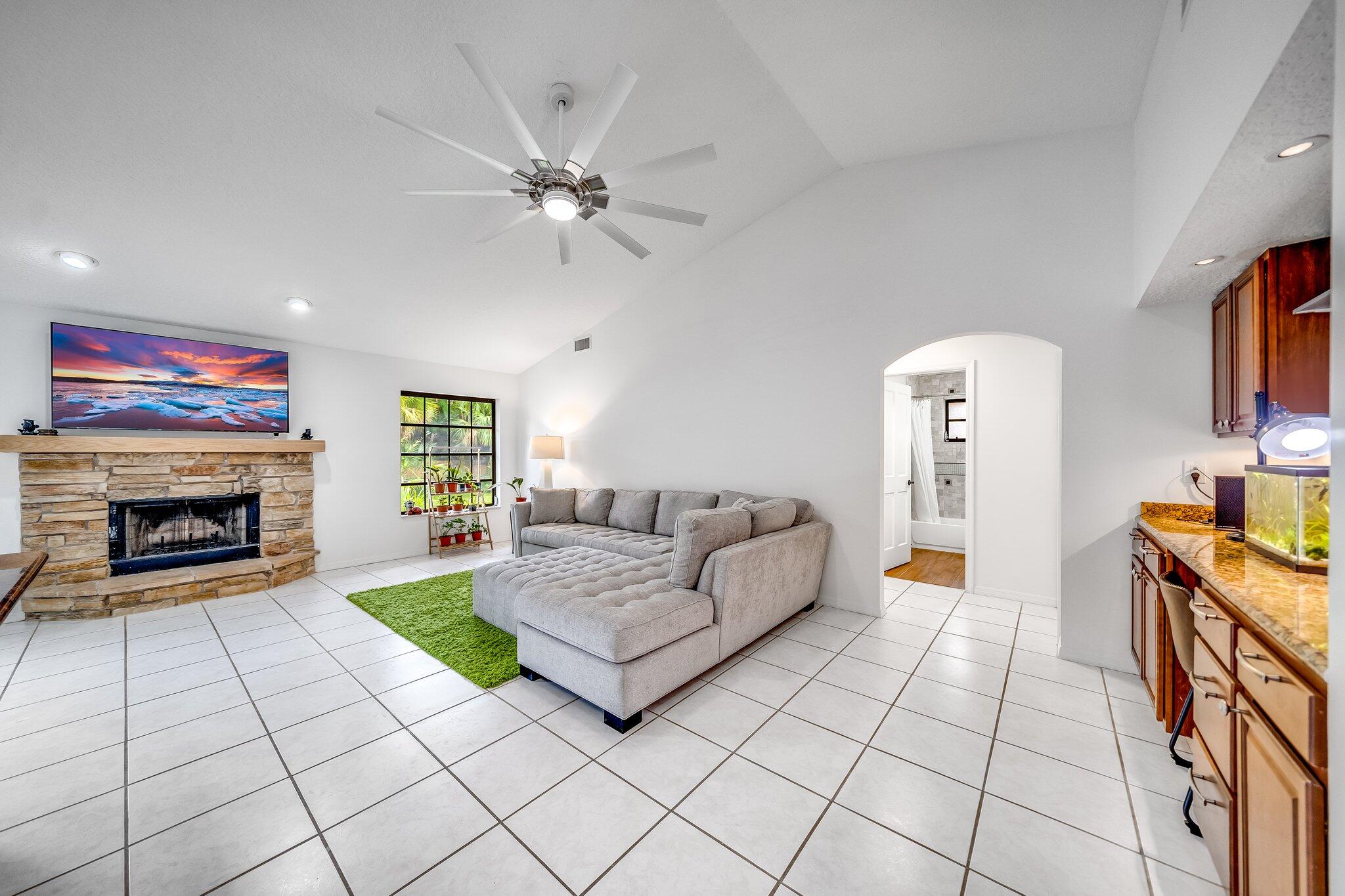 9268 Rodeo Drive Lake Worth, FL 33467 - Photo 7 of 66 a living room with furniture and a fireplace