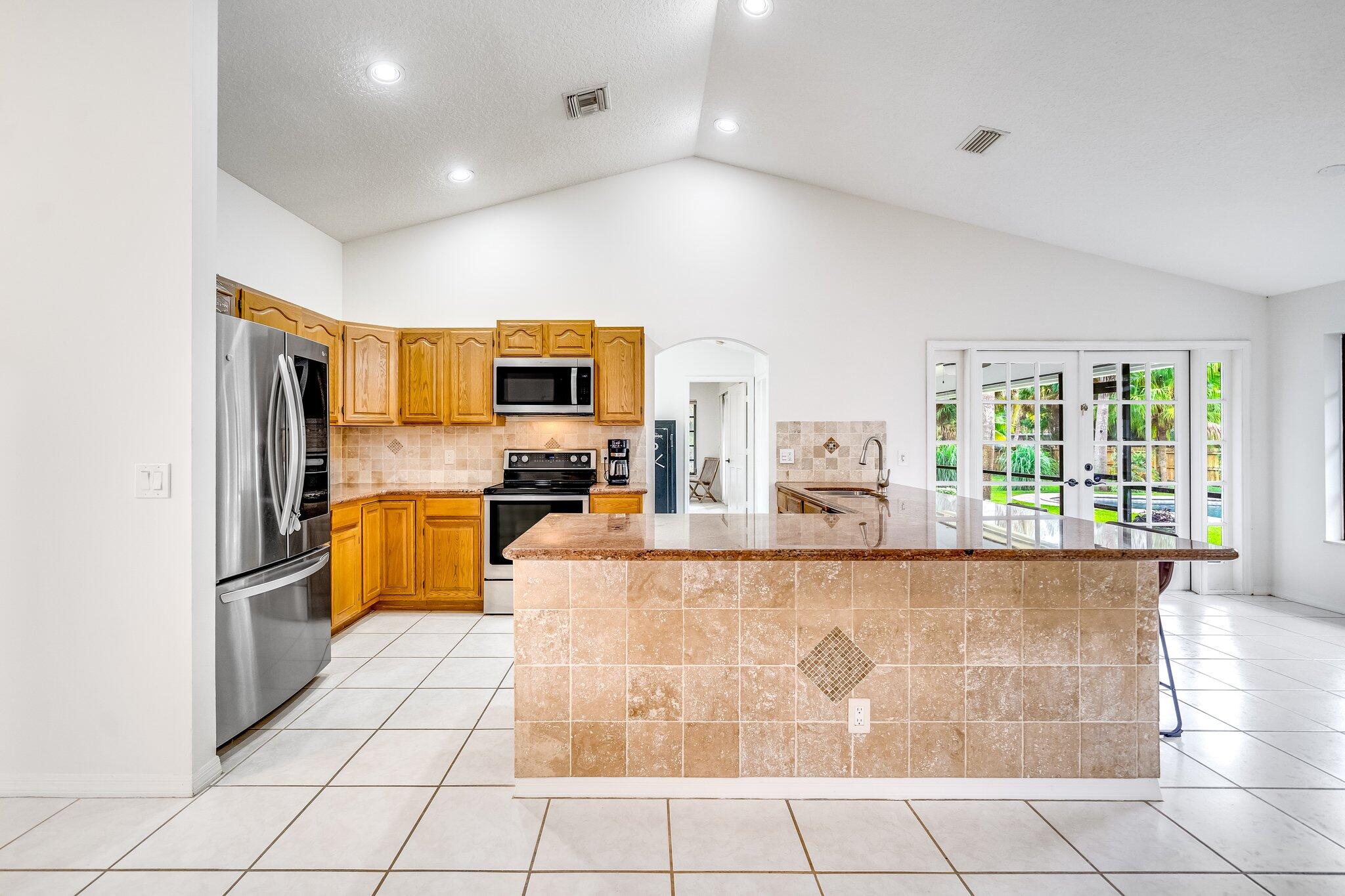 9268 Rodeo Drive Lake Worth, FL 33467 - Photo 9 of 66 a large kitchen with cabinets and stainless steel appliances