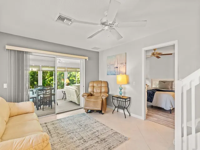a living room with furniture and a floor to ceiling window