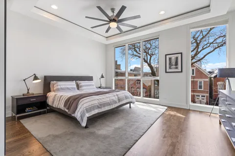 a bedroom with a large bed and a chandelier