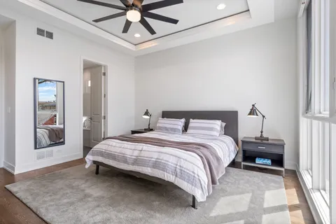 a bedroom with a bed and a chandelier