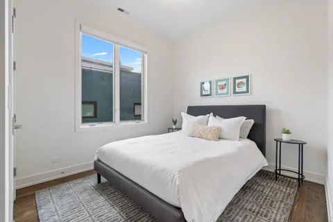 a bedroom with a bed and a window