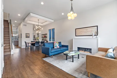 a living room with furniture and a chandelier