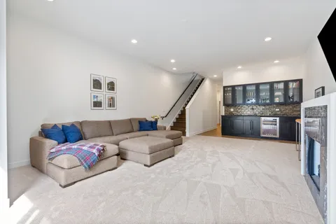 a living room with furniture and kitchen