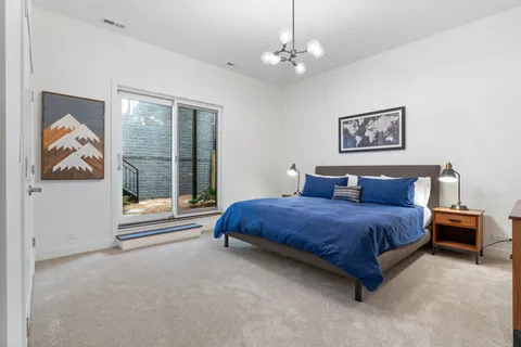 a spacious bedroom with a bed and window