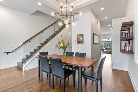 a view of a dining room with furniture and wooden floor