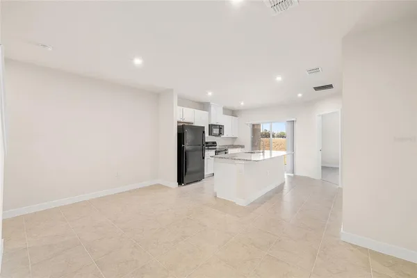 a large kitchen with kitchen island a sink stainless steel appliances and cabinets
