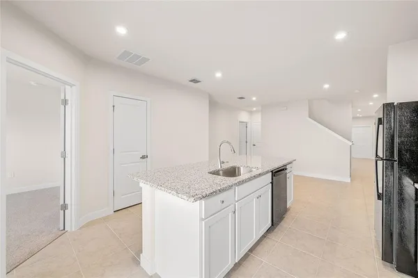 a kitchen with stainless steel appliances kitchen island granite countertop a sink and cabinets