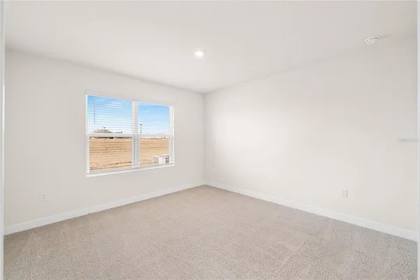 a view of an empty room and closet area