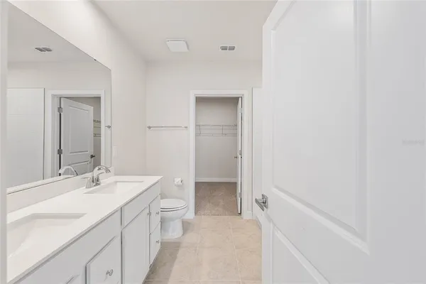 a bathroom with a double vanity sink toilet and shower