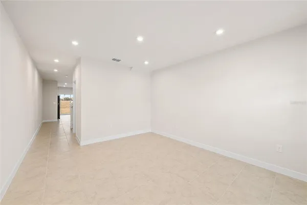 an empty room with a empty space and windows