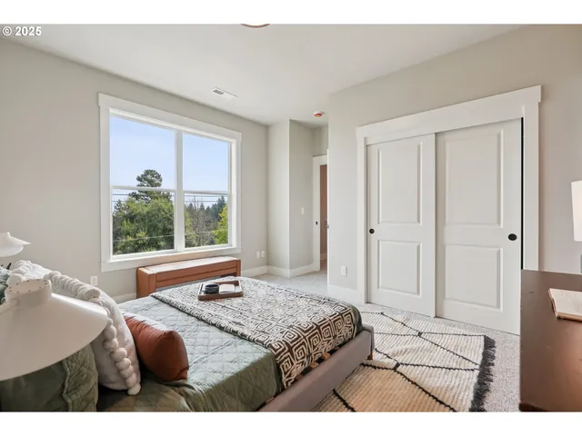 a bedroom with a bed and a window