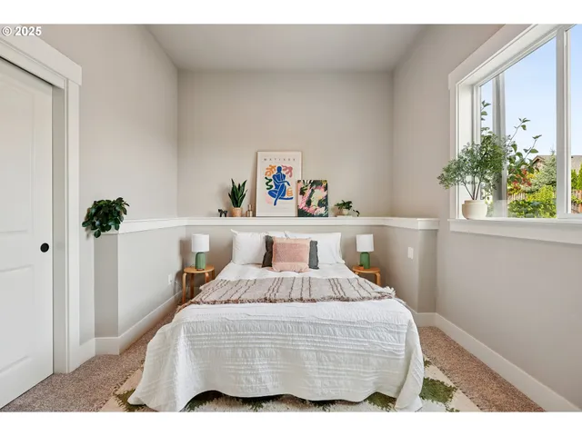 a bedroom with a bed and a potted plant