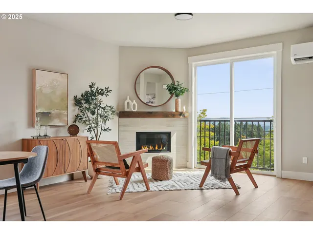a living room with furniture a fireplace and a floor to ceiling window