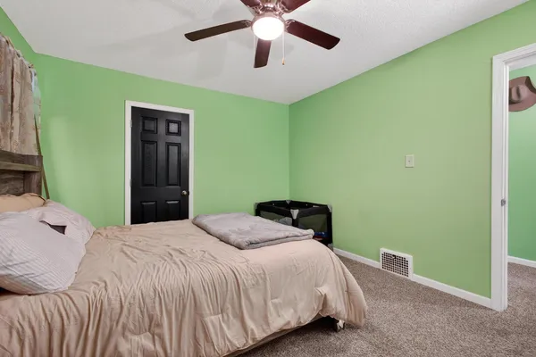 a bedroom with a bed and a chandelier