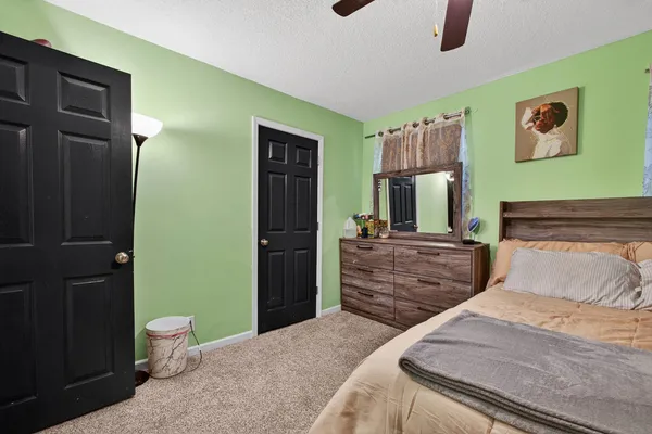 a bedroom with a bed and a view of bathroom