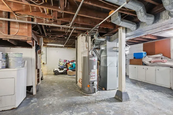 a view of a storage room with water heater and racks