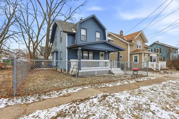 a view of a house with a yard covered in snow