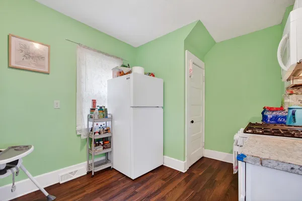 a room with hard wood floors and a white cabinet