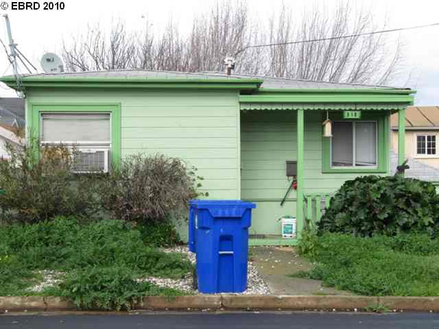 318 Second Street Rodeo, CA 94572 - Photo 1 of 1 a front view of a house with a garden