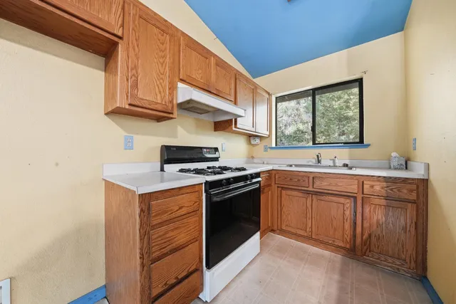 a kitchen with stainless steel appliances granite countertop a stove and a sink