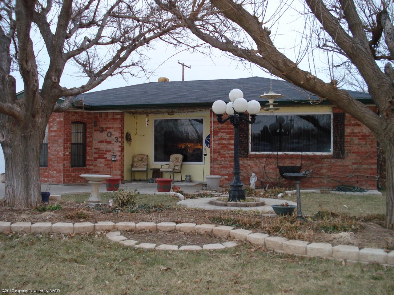 5203 South Austin Street Amarillo, TX 79110 - Photo 1 of 1 a front view of a house with garden
