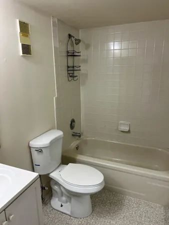 a bathroom with a toilet a sink and shower