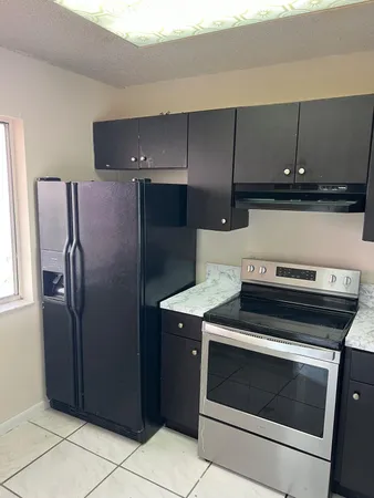 a stove top oven sitting inside of a kitchen