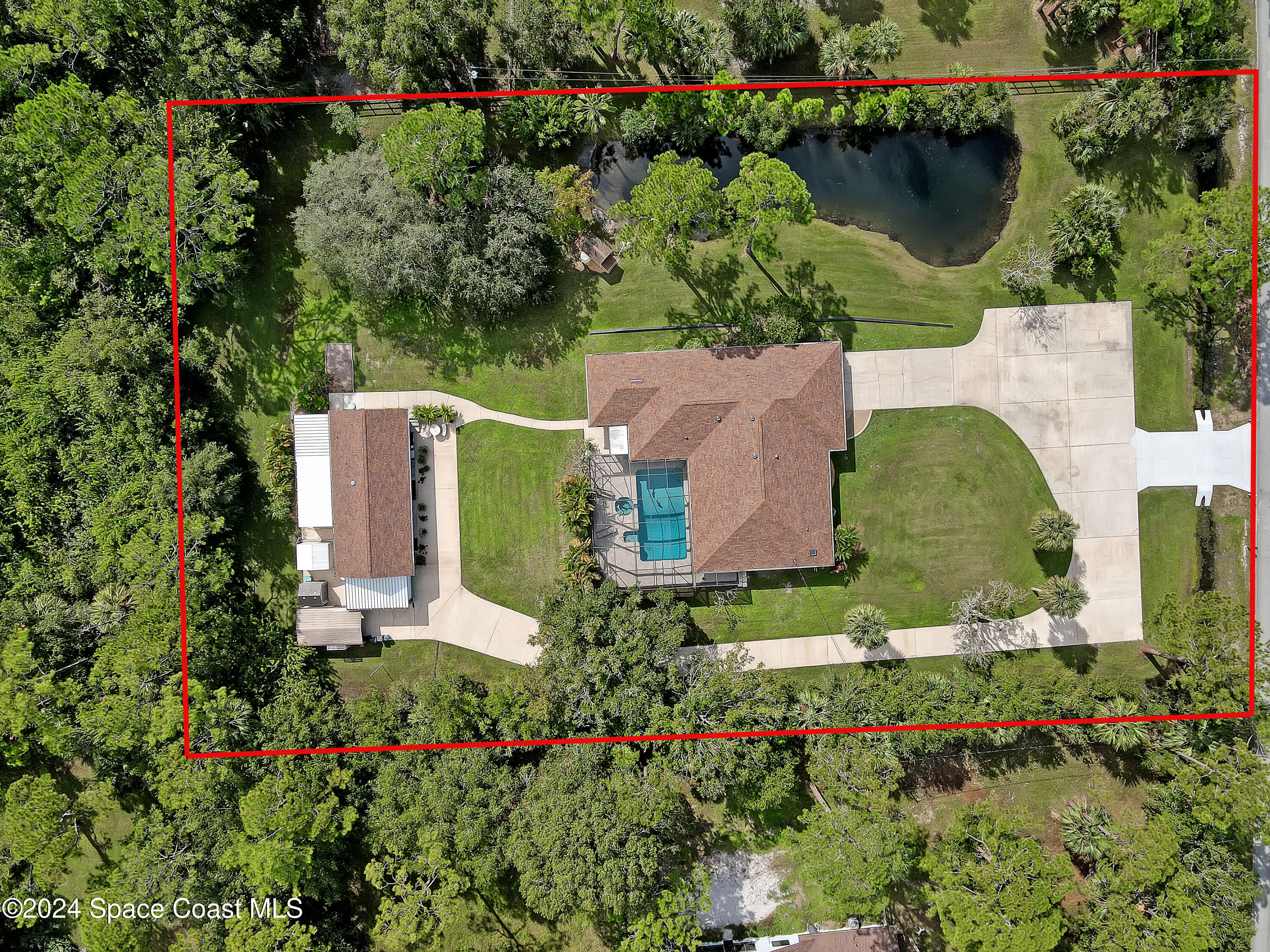 3865 Corey Road Malabar, FL 32950 - Photo 1 of 72 an aerial view of a house with a garden and swimming pool