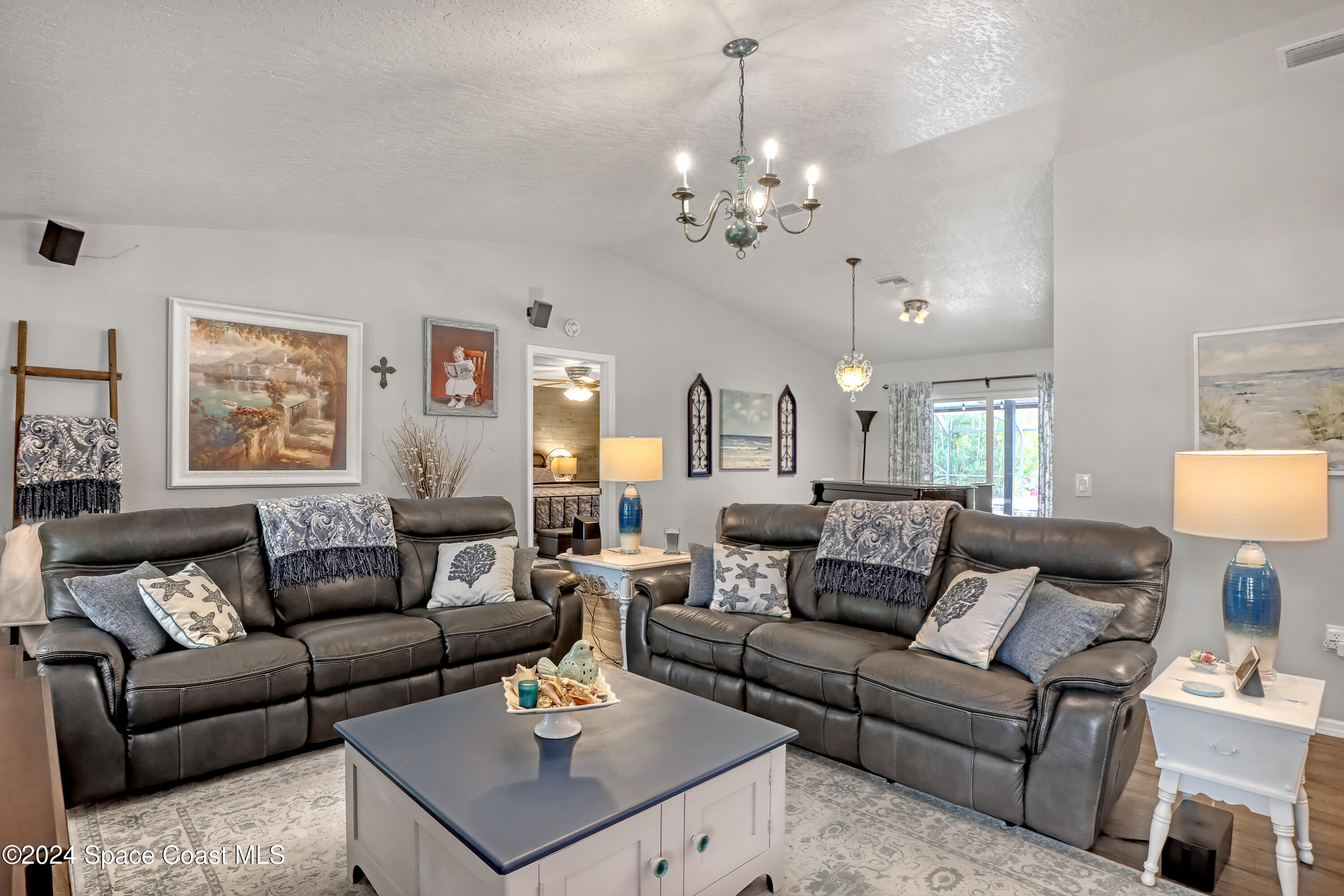 3865 Corey Road Malabar, FL 32950 - Photo 13 of 72 a living room with furniture a chandelier and a table