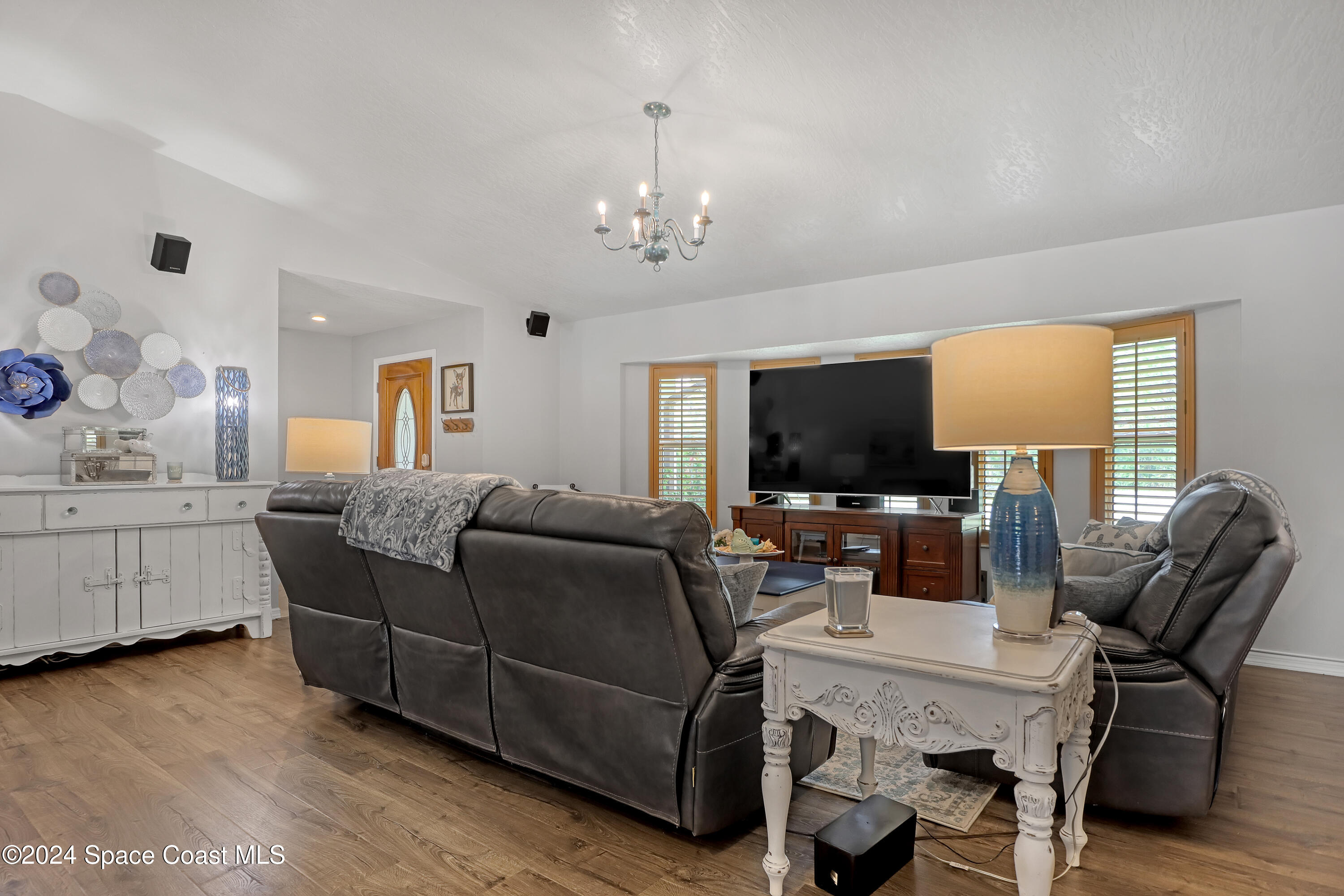 3865 Corey Road Malabar, FL 32950 - Photo 14 of 72 a living room with furniture and a flat screen tv