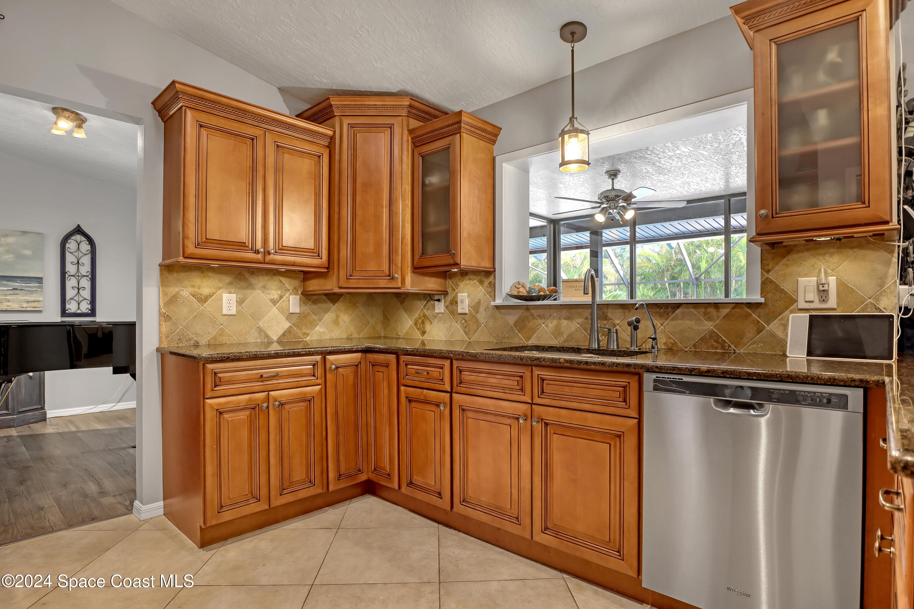3865 Corey Road Malabar, FL 32950 - Photo 22 of 72 a kitchen with stainless steel appliances granite countertop a sink a stove and cabinets