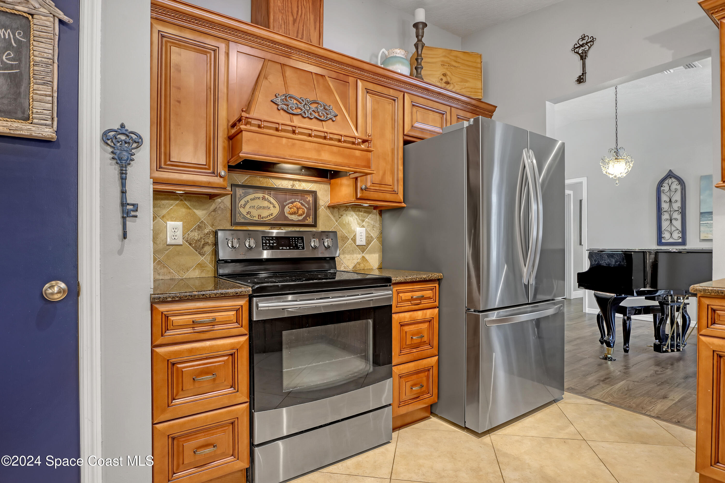 3865 Corey Road Malabar, FL 32950 - Photo 24 of 72 a kitchen with stainless steel appliances granite countertop a refrigerator a stove and a sink with granite countertops