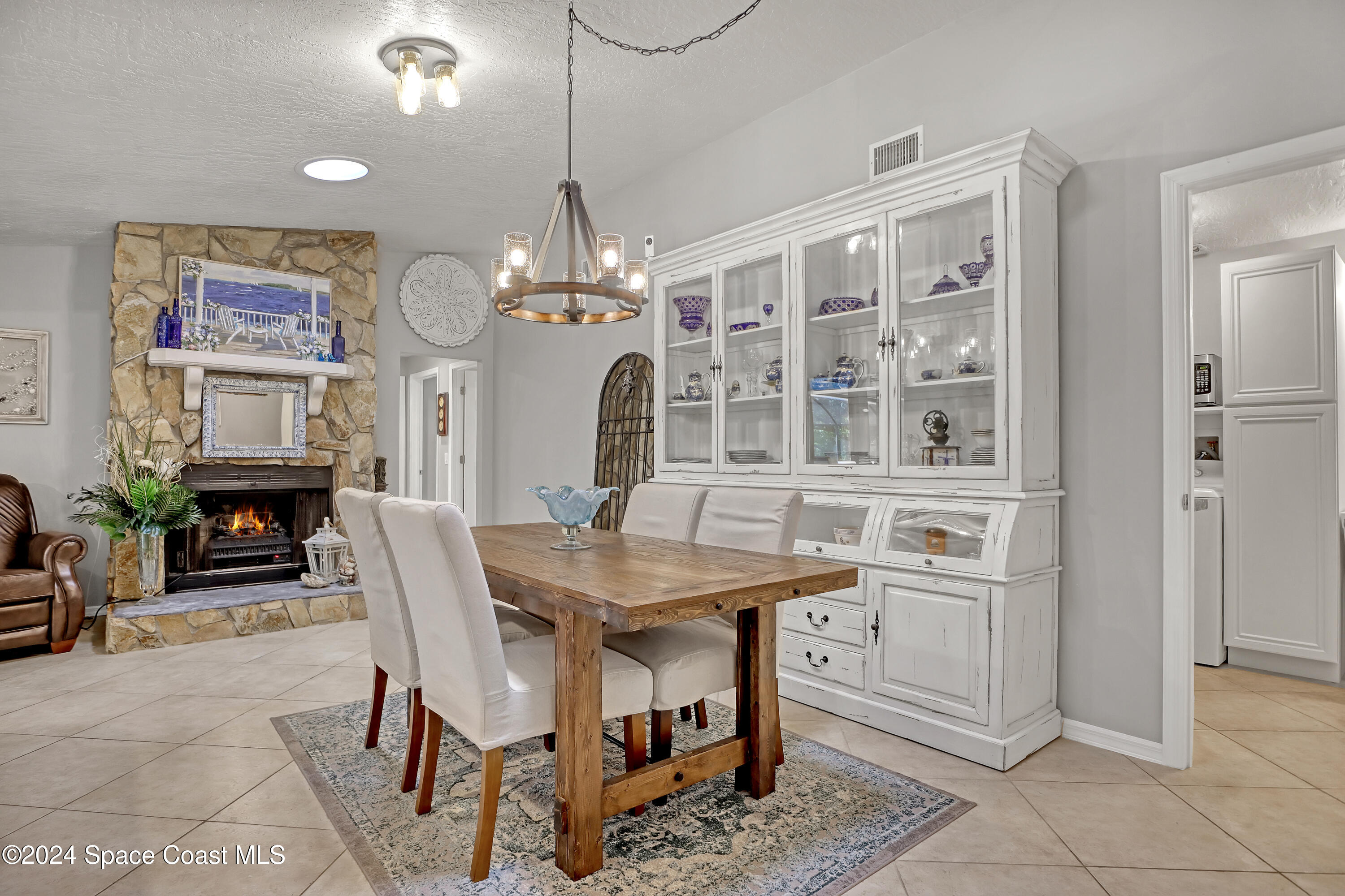 3865 Corey Road Malabar, FL 32950 - Photo 26 of 72 a view of a dining room with furniture and chandelier