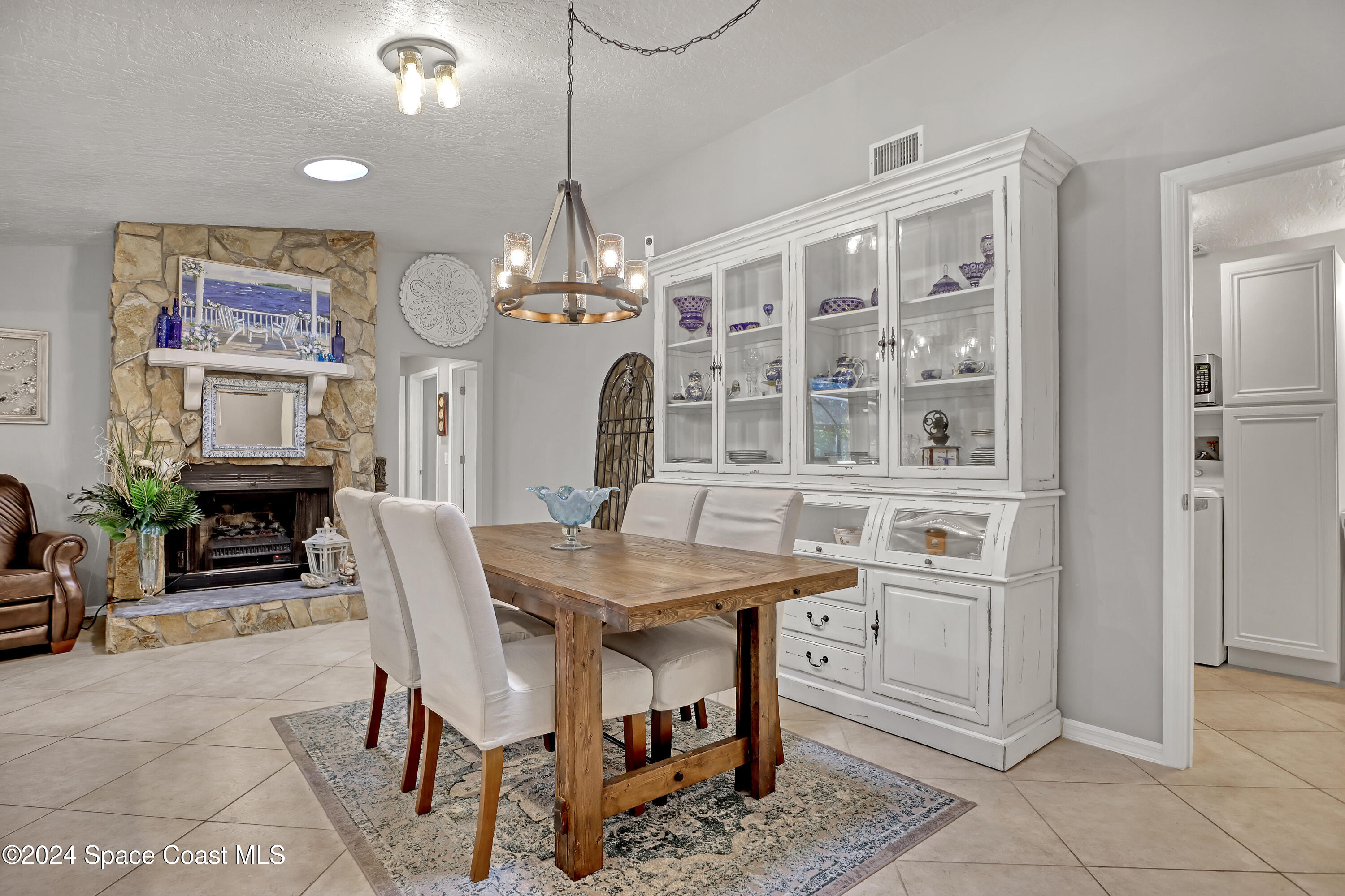 3865 Corey Road Malabar, FL 32950 - Photo 28 of 72 a view of a dining room with furniture and chandelier