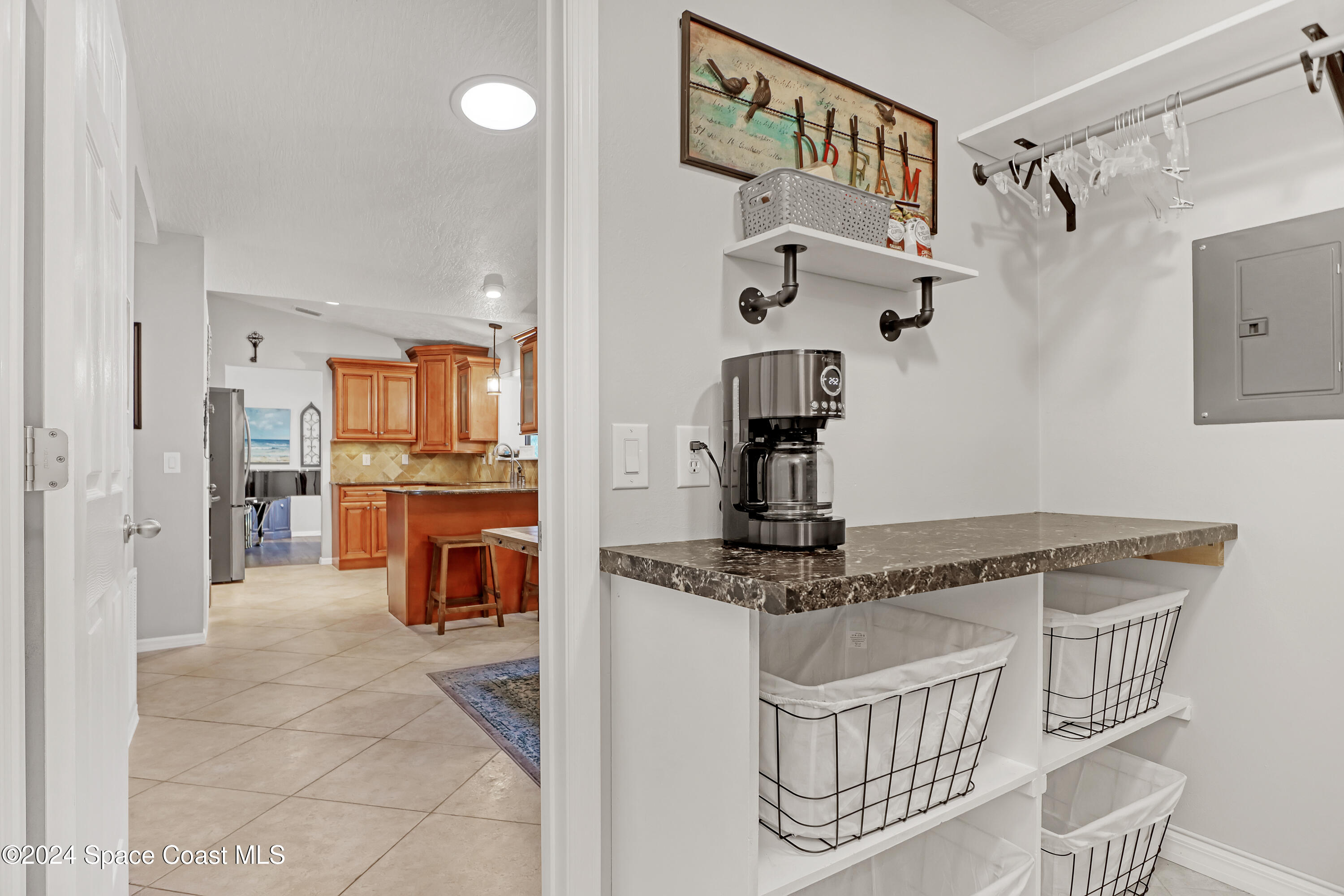 3865 Corey Road Malabar, FL 32950 - Photo 29 of 72 a kitchen with stainless steel appliances granite countertop a sink and a refrigerator