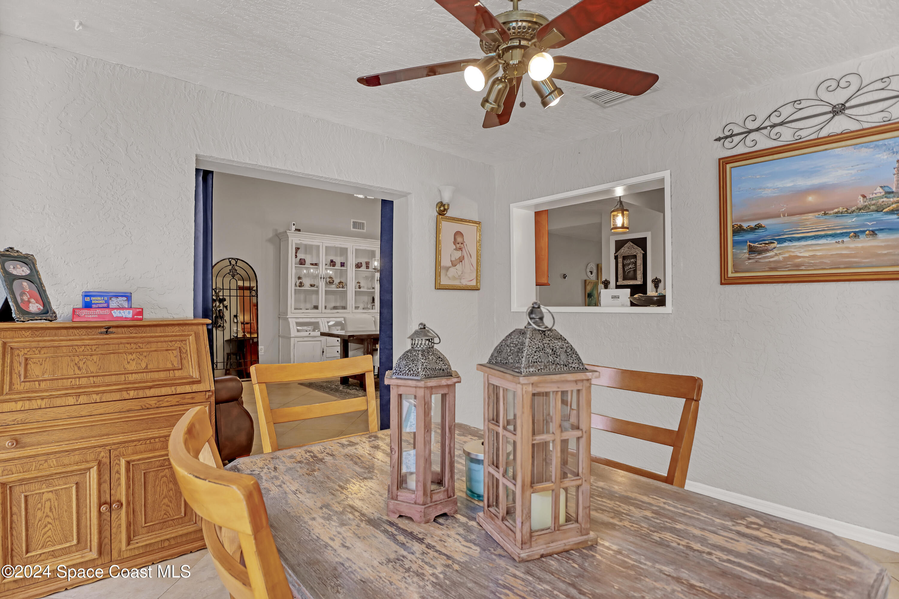 3865 Corey Road Malabar, FL 32950 - Photo 31 of 72 a view of a dining room with furniture a chandelier and wooden floor