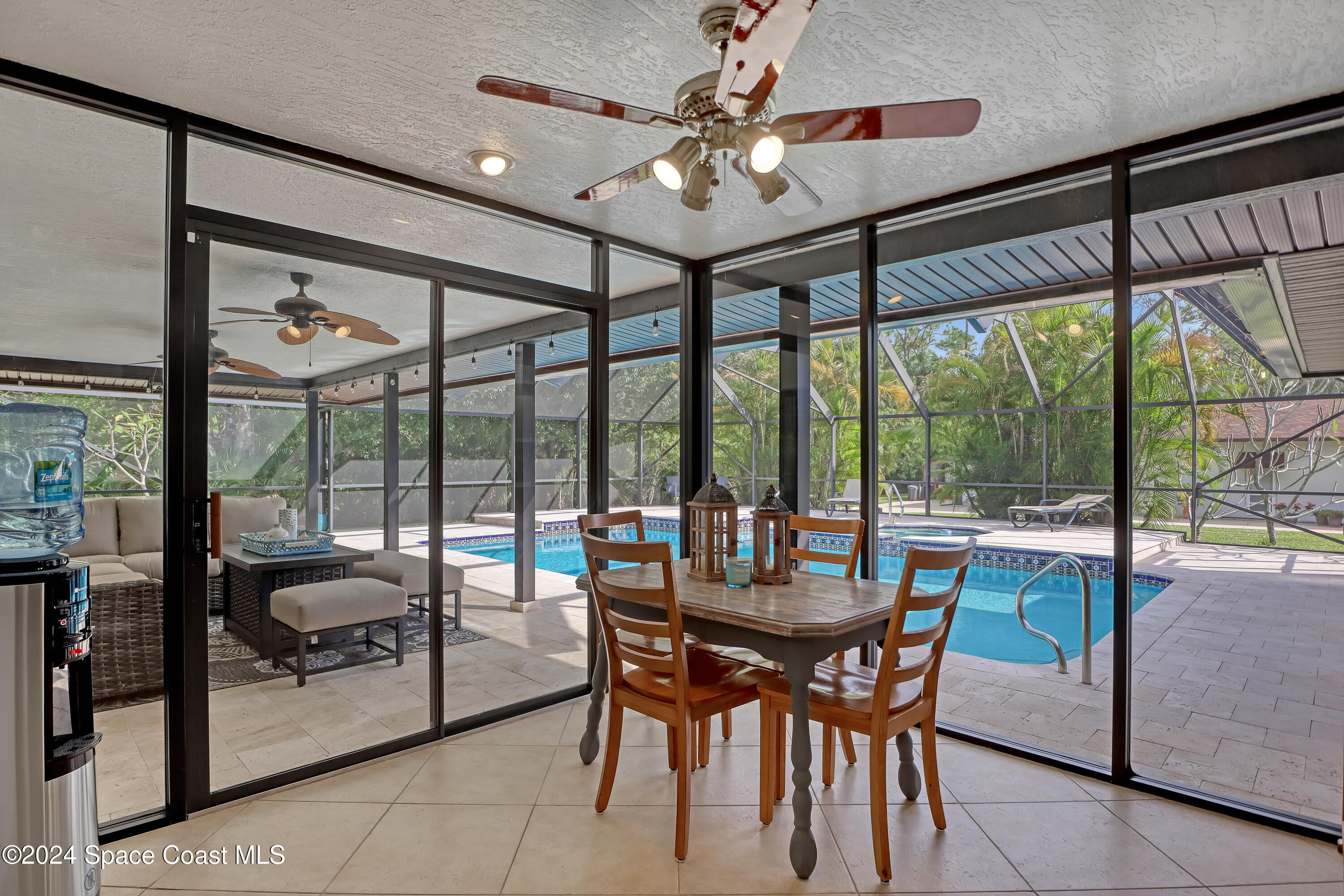 3865 Corey Road Malabar, FL 32950 - Photo 32 of 72 a dining room with furniture water view and a floor to ceiling window