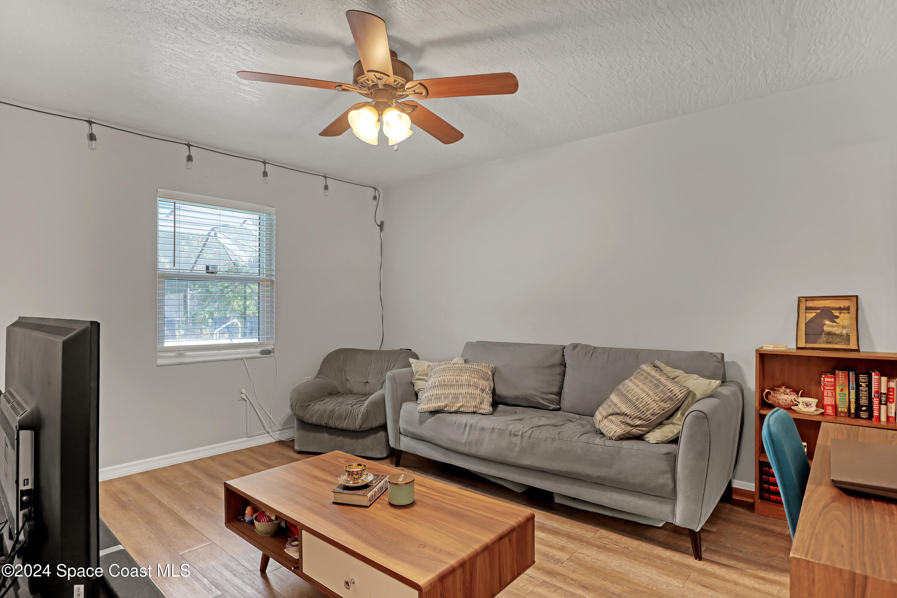 3865 Corey Road Malabar, FL 32950 - Photo 37 of 72 a living room with furniture and a window
